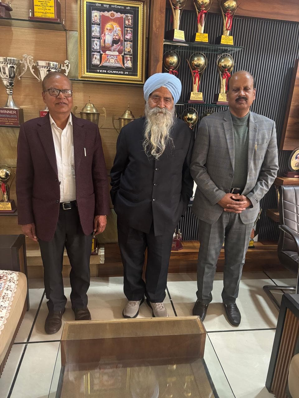 Three people standing together in a professional setting