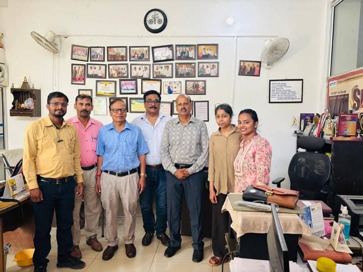 A small professional team gathered in an office
